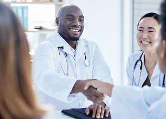 Image showing Doctors, handshake and healthcare meeting in agreement, teamwork welcome and collaboration. Happy medical employee, black man and shaking hands in partnership, greeting and success of hospital trust