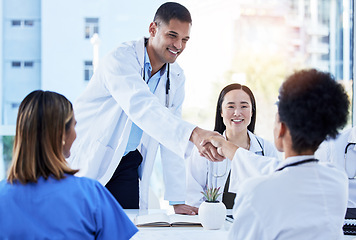 Image showing Handshake, doctors and medical meeting in agreement, collaboration and smile of teamwork, welcome or deal. Happy healthcare employees shaking hands in hospital partnership, greeting or clinic success