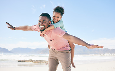 Image showing Beach, black man flying with child on back and playful family holiday in Australia with freedom and energy. Travel, fun and happy father and girl with smile playing and bonding together on vacation.