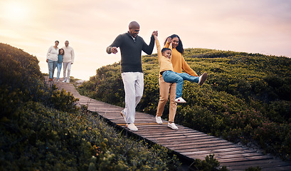 Image showing Family, walking or sunset with parents, kids and grandparents playing together outdoor in nature. Spring, love or environment with children and senior relatives taking a walk while bonding