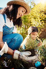 Image showing Family, kids or gardening with a mother and daughter planting plants in the backyard together. Nature, children or landscaping with a woman and female child working in the garden during spring