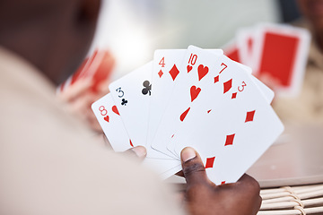 Image showing Game, holding and man playing cards, poker or black jack at a casino. Back, games and a guy showing a card in hands while gambling, having fun and learning a magic trick for s hobby or activity