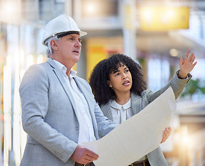 Image showing Man, woman and pointing at construction site for blueprint ideas, industrial design or collaboration. Team discussion, building management and engineering of infrastructure, architecture and planning