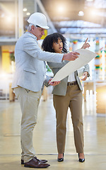 Image showing Man, woman and construction team brainstorming at building site with blueprint, ideas or design. Diversity, project management and architect pointing to infrastructure, engineering and floor planning