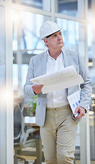 Image showing Mature man, blueprint and construction manager walking in building site, project management and design. Engineering, contractor and thinking of floor plan for architecture, development and innovation