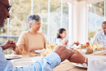 Image showing Praying, spiritual and family praise God before dinner or supper as gratitude together in dining room. Holding hands, religion and thankful Christian people in hope, worship and prayer at a table