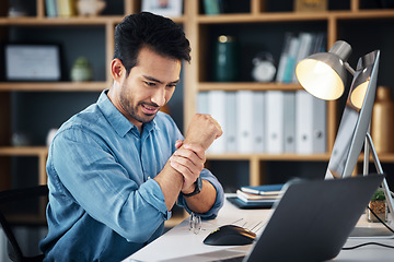 Image showing Businessman working in the office with wrist pain, injury or accident medical emergency. Healthcare, professional and male employee sitting at his desk with sprain muscle in his hand in the workplace