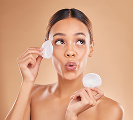 Image showing Skincare, dermatology and woman with cotton pad, organic facial and treatment against a brown studio background. Female, lady and makeup remover with cosmetics, grooming and wellness with smooth skin