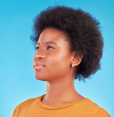 Image showing Thinking, idea and black woman wondering looking away in thought isolated against a blue studio background. Afro, casual and face of young African American female relax, calm and confident