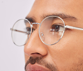 Image showing Zoom, optometry and face of a man with glasses for vision, intelligence and eyecare. Looking, serious and guy wearing fashionable eyeglasses, showing frame and fit isolated on a studio background