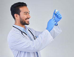 Image showing Covid, vaccine and happy man doctor in studio, excited for medicine, breakthrough or cure on grey background. Medical, innovation and face of male corona expert with futuristic health treatment