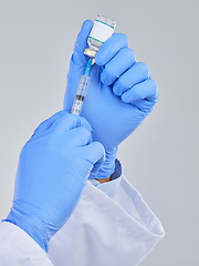 Image showing Vaccine vial, needle and doctor hands in studio for safety, healthcare and pharmaceutical medicine. Closeup person, vaccination and injection bottle for virus, immunity and medical antibiotics drugs