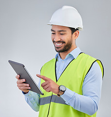 Image showing Construction worker, engineer and happy man in studio with tablet and helmet safety on white background. Smile, internet and contractor or architect in online planning for project management in India