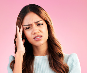 Image showing Headache, stress and pain, portrait of woman in studio, tired and depression isolated on pink background. Mental health, burnout and depressed hispanic model with hand on head and temple massage.