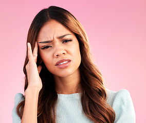 Image showing Stress, burnout and woman with headache in studio, tired or exhausted on pink background. Mental health, depression and anxiety, overworked hispanic model with hand on head in pain and temple massage