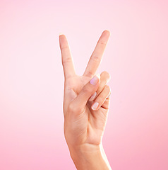 Image showing Woman, hands and peace sign, emoji or symbol for freedom against a pink studio background. Hand of female showing peaceful V icon or shape for hope, support or trust in vote or voice on mockup