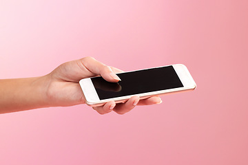 Image showing Hands, phone mockup and screen in studio isolated on a pink background. Cellphone, social media and woman with mobile smartphone for branding, advertising or marketing for product placement space.