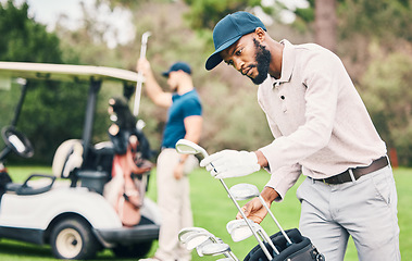 Image showing Golf, club and black man choose on course with golfing bag ready to start game, practice and training. Professional golfer, activity and male caddy with choice for exercise, fitness and recreation