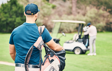 Image showing Golf, sports and back of man on course with golfing bag of clubs ready to start game, practice and training on lawn. Professional golfer, activity and male caddy for exercise, fitness and recreation