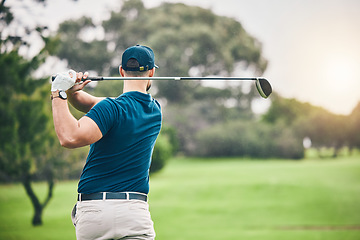 Image showing Sports, golf and man swing driver on field for exercise, training or workout match. Fitness, golfing course and male golfer swinging club for practice, competition or game for recreation outdoors.