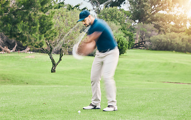 Image showing Golf, stroke and motion blur with a sports man swinging a club on a field or course for recreation and fun. Golfing, grass and training with a male golfer playing a game on a green during summer