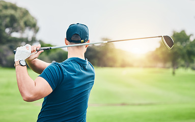 Image showing Golf, stroke and back with a sports man swinging a club on a field or course for recreation and fun. Golfing, grass and training with a male golfer playing a game on a green during summer