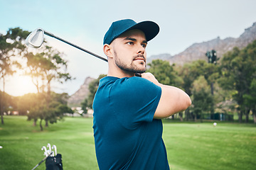 Image showing Golf, focus and hobby with a sports man swinging a club on a field or course for recreation and fun. Golfing, grass and stroke training with a male golfer playing a game on a green during summer