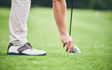 Image showing Sports, golf ball and tee with hand of man on course for training, tournament and challenge. Start, competition match and ready with athlete and club on grass field for action, games and hobby