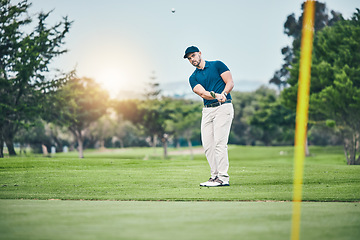 Image showing Golf, stroke and aim with a sports man swinging a club on a field or course for recreation, fun and hobby. Golfing, grass and training with a male golfer playing a game on a green during summer