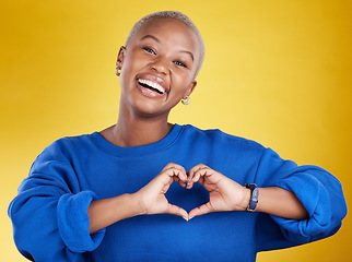 Image showing Heart hands, portrait and happy black woman in studio, background and color backdrop for emoji. Smile, female model and finger shape for love, thank you and support of peace, care or sign of kindness