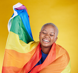 Image showing Laughing, lgbtq and black woman with pride flag in studio isolated on a yellow background. Gay, homosexual and lesbian, queer or funny, happy or comic African female with banner for trans or bisexual