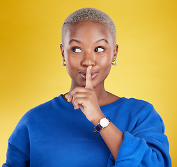 Image showing Secret, face and black woman with finger on lips in studio, background and privacy of drama news. Female model, silence and quiet on mouth, shush and gossip in whisper, emoji or confidential surprise
