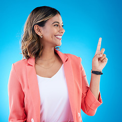 Image showing Smile, mock up and Indian woman in studio pointing up for product placement, mockup or information. Deal, promotion or announcement, happy model showing info space or notification on blue background.