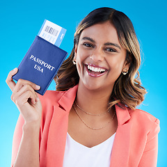 Image showing Passport, excited and woman portrait isolated on blue background for USA travel opportunity, immigration or holiday. Identity documents, flight ticket and happy face of young indian person in studio