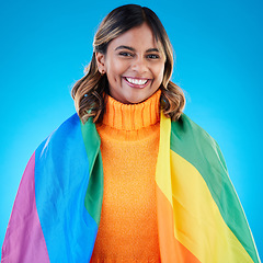 Image showing Portrait, pride and woman with rainbow flag, queer and acceptance against a blue studio background. Face, female and happy girl with symbol for lgbtq community, equality and transgender with support