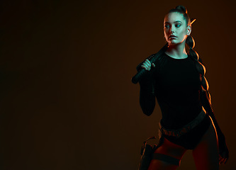Image showing Warrior, woman and sword with space in studio for action, fight and safety from danger. Strong female vigilante, assassin or agent in scifi cosplay costume with weapon for mockup dark background