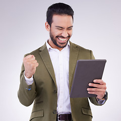 Image showing Success winner man on tablet isolated on studio background fist pump for stock market, trading or business news. Winning profit of asian person on digital tech celebration, bonus or sales achievement