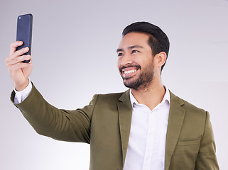 Image showing Businessman, face and selfie with smile for profile picture, vlog or social media against a white studio background. Happy isolated employee man smiling on smartphone for photo, memory or online post