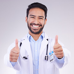 Image showing Thumbs up portrait of man doctor isolated on a white background in healthcare success, thank you and service support. Like, yes and ok hands sign with face of medical worker or asian person in studio