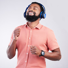 Image showing Music headphones, dance and happy black man streaming song for studio fun, freedom and wellness. Dancing energy, audio podcast and person listening to radio, media sound or track on white background