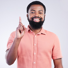 Image showing Black man, studio portrait and point finger for answer, question and smile with confidence by background. Young model, african student and hand gesture with happiness on face for fashion by backdrop