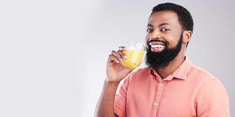 Image showing Orange juice, portrait and happy black man drinking with glass for hydration, liquid detox or weight loss. Vitamin C benefits, male nutritionist beverage and studio person on mockup gray background