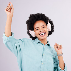 Image showing Portrait, happy dance music or black woman streaming song for studio fun, freedom or wellness. Dancing energy, audio podcast or person listening to radio, media headphones or track on gray background