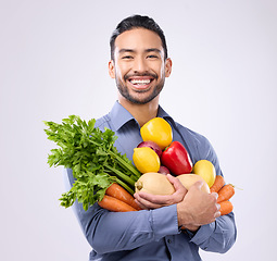 Image showing Healthy, groceries and portrait of an Asian man with vegetables isolated on a white background in a studio. Smile, holding and a Japanese male with food for a diet, vegan lifestyle and nutrition