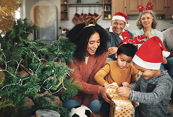 Image showing Love, Christmas and family opening presents, festive and happiness with quality time, joy and bonding. Grandparents, mother and children with gifts, Xmas and loving together with smile or celebration