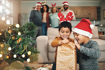 Image showing Christmas, curious and children opening gifts, looking at presents and boxes together. Smile, festive and kids ready to open a gift or present under the tree for celebration of a holiday at home