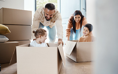 Image showing Playful, fun and a family moving into a house, bonding and unpacking their new home together. Happy, game and young parents pushing their children in a box, playing and relocation to an apartment