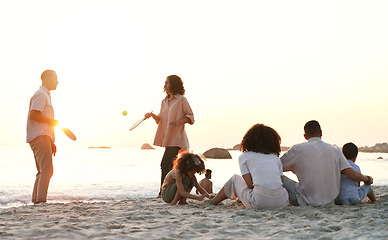 Image showing Travel, game and family at the beach on a summer vacation, adventure or weekend trip in Australia. Sunset, fun and people playing sports on the sand by the ocean on seaside holiday together.