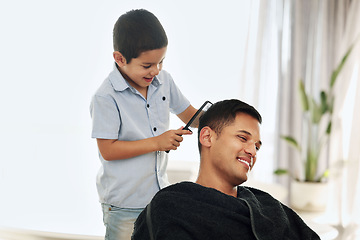 Image showing Father, family and kid comb hair in home for grooming, cleaning and styling. Smile, hairdresser and happy boy or child combing man and dad for new look or hairstyle while bonding and playing in house