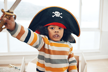 Image showing Pirate, box and portrait of black child in living room for creative, playful and fantasy. Sailing, games and imagine with kid playing in cardboard boat at home for comedy, childhood and youth